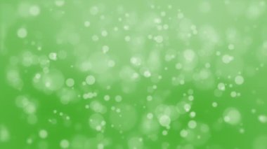 Yüzen kabarcık ışık parçacıkları ile canlandırılmış yeşil bokeh arkaplan.