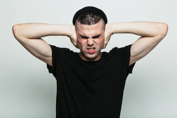 Male squinting with force to back away from what is happening — Stock Photo, Image