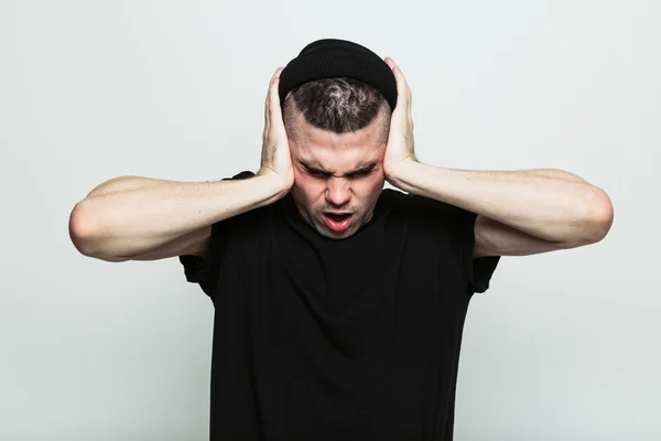 Tired man covering his ears — Stock Photo, Image