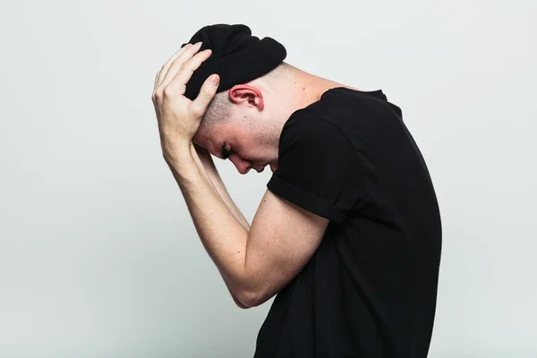 Emotional man possing with hands on head — Stock Photo, Image
