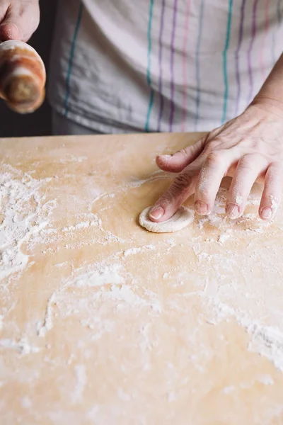 Two hands making dough for meat dumplings. — Stock Photo, Image