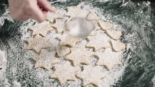 Person putting raw cookies to flour — Stock Video