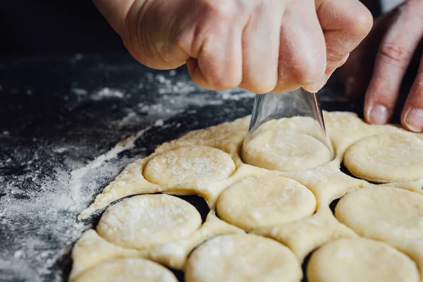 Person shaping cookies with shot glass — Stock Photo, Image