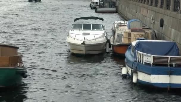 Widok na zacumowane łodzie na biegunach na fale — Wideo stockowe
