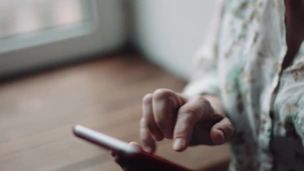 Женщина смотрит что-то на экране смартфона — стоковое видео