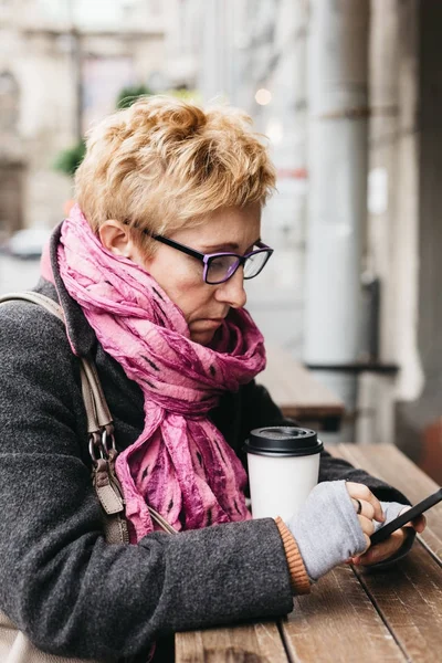 Kadın Smartphone dış kafede tarama