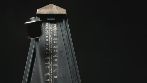 Close-up shot of vintage metronome with golden pendulum — Stock Video