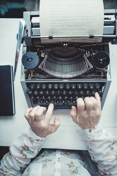 Writer typing with retro writing machine. Stock Photo by ©kkolosov