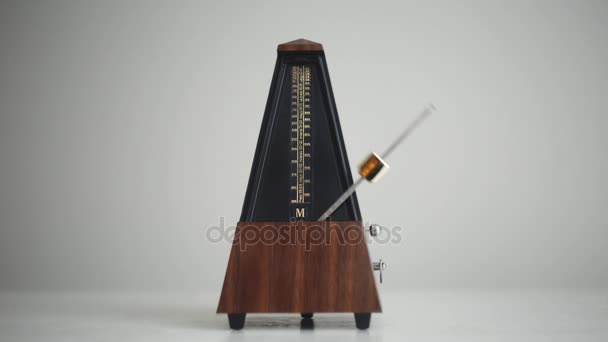Vintage metronome with golden pendulum beats slow rhythm — Stock Video