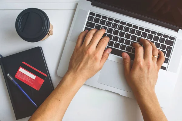 Man working on laptop placed on white desk — Stock Photo, Image