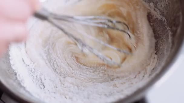 Chef stir with a whisk the ingredients for the dough — Stock Video