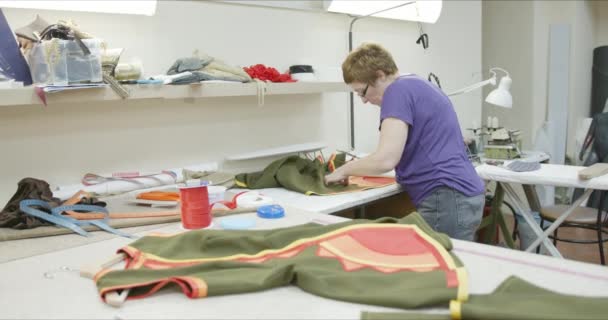 Seamstress works on a garment — Stock Video
