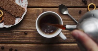Coffee pour into cup from big coffee maker