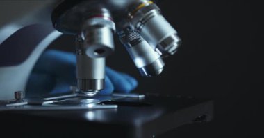 Crop closeup shot of microscope in the laboratory, scientist is conducting study examines