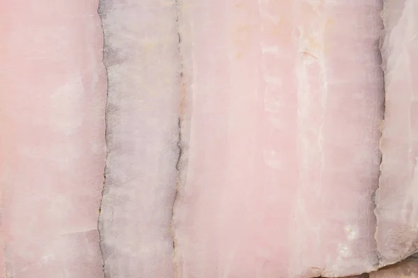 Lightened slices marble onyx. Horizontal image. Warm pink colors. Beautiful close up background — Stock Photo, Image