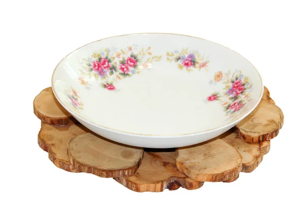 White plate  from tea pair from a saucer cup on a juniper stand — Stock Photo, Image
