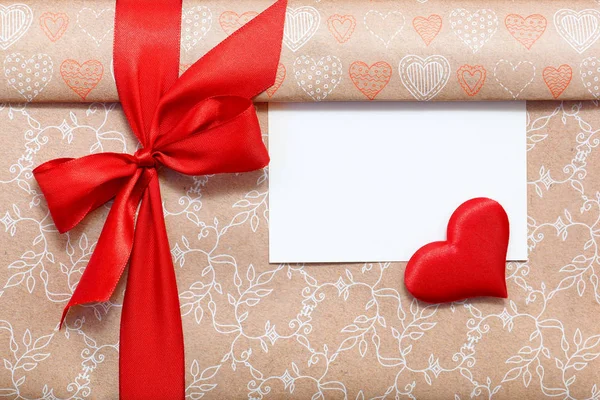 Congratulatory background. A gift box tied with a red ribbon. — Stock Photo, Image