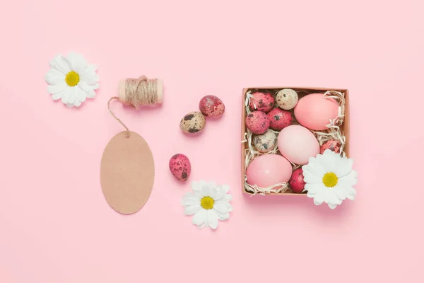 Easter eggs on pink background. Top view. Copyspace. Background with easter eggs. Pink eggs with flowers. Easter photo concept. Easter gifts.