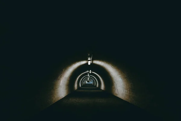 Dark urban tunnel without people.