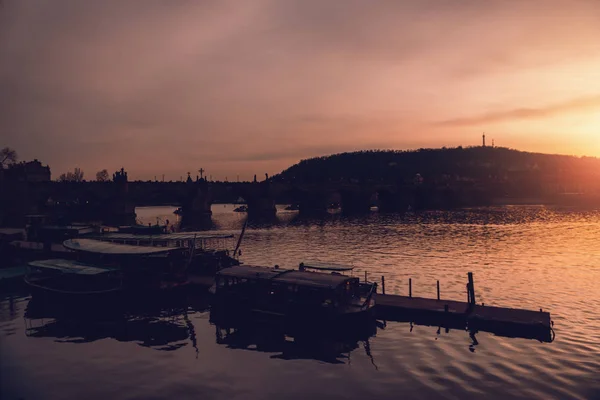 Akşam Prag'da. Avrupa şehri günbatımı üzerinde. Nehir yansımaları ile. Barok ve Gotik mimarisinin siluet.