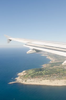 Bir uçağın penceresinden kıyı manzara.