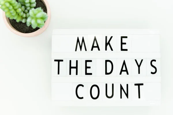 Positive inspiring quote on lightbox: make the days count.