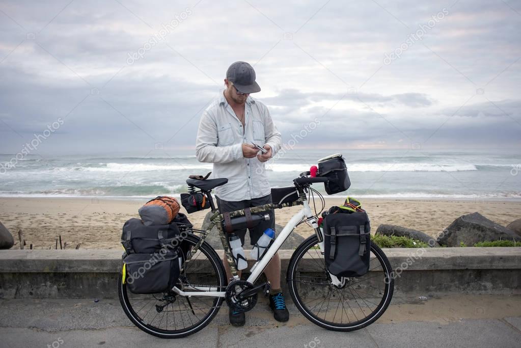 Long Distance Cyclist with Bicycle by Ocean