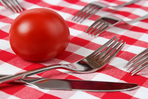 Tomato, knife and forks — Stock Photo, Image