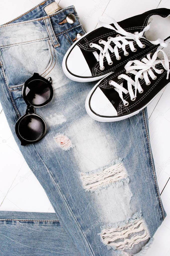 fashionable jeans with sneakers on a white background