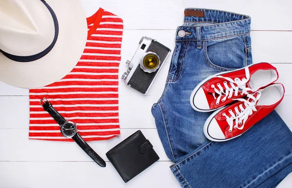 Fashionable t-shirt, jeans, old camera, hat and sunglasses on a white background — Stock Photo, Image