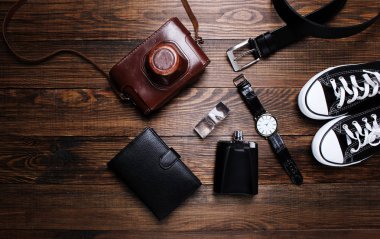 moda. saat, cüzdan, kemer, Köln, spor ayakkabı ve ahşap arka plan üzerinde eski fotoğraf makinesi