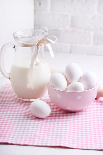 natural milk and eggs in a plate on a table