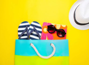 Sarı bir arka plan üzerinde şık plaj aksesuarları