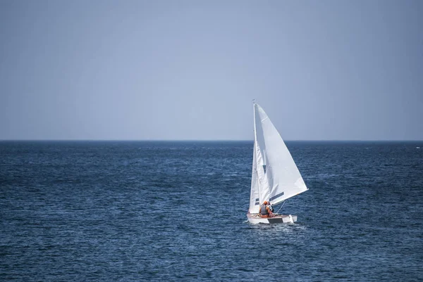 Sailboat gliding over the ocean surface