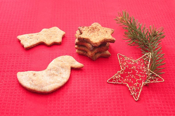 Christmas cookies and decorations on red background — Stock Photo, Image