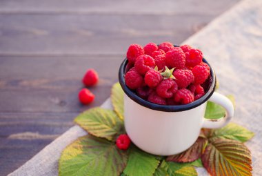Bir demir kupa içinde ahududu taze çilek 