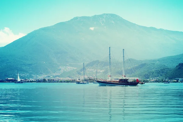 Морський пейзаж з яхтами. Яхта нарізана проти гір . — стокове фото