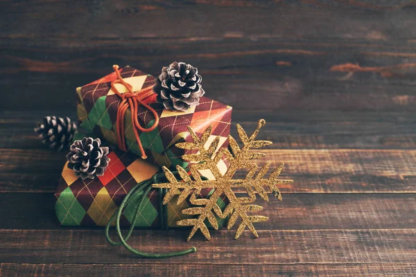 Festive boxes in colourful paper on a wooden background in vintage color. — Stock Photo, Image