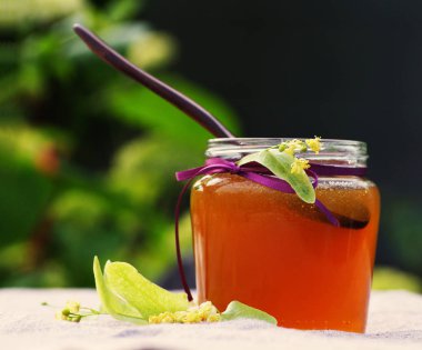 Yeşiller karşı bir Ihlamur çiçekleri bir cam kavanoza yaz günde tatlım.