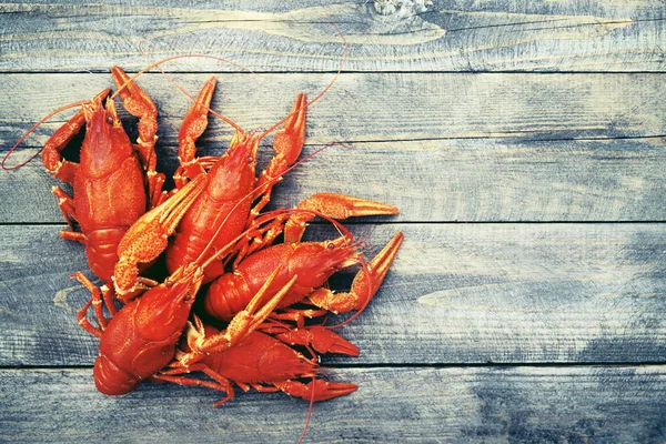 Boiled crawfish on a wooden background