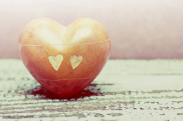 Heart with stones on an old wooden background. — Stock Photo, Image