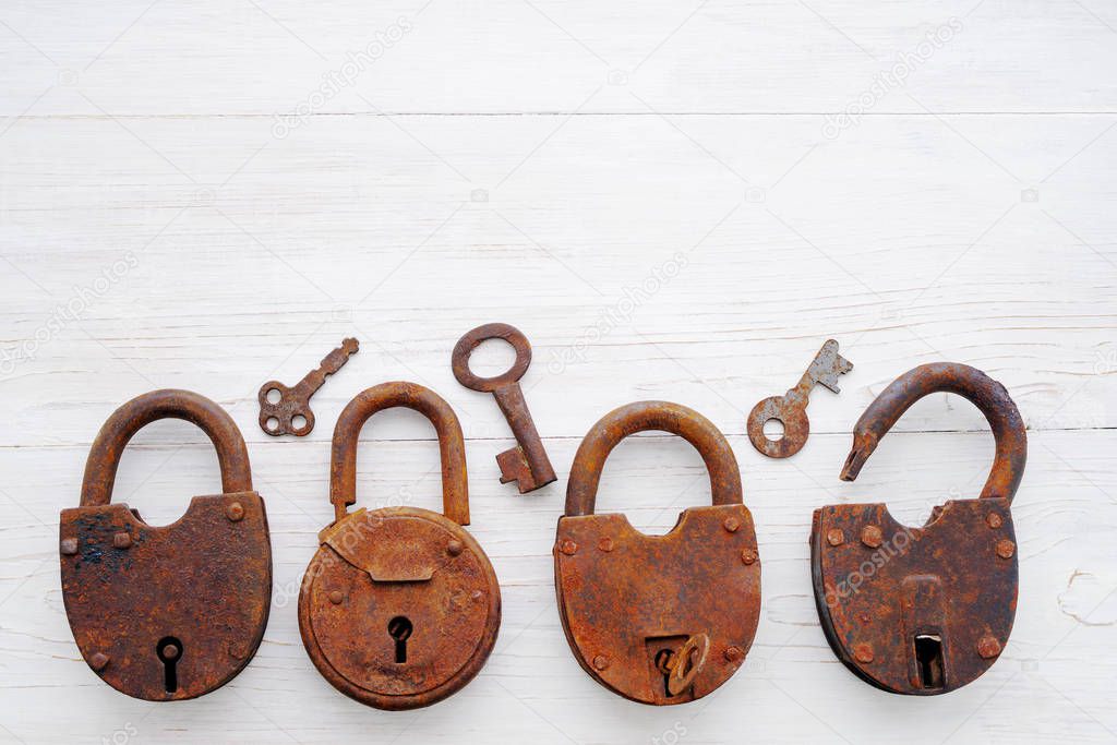 Old rusty padlocks and keys on a wooden  background