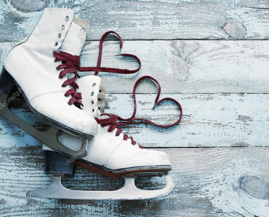 Old white skates for figure skating with a hearts of laces