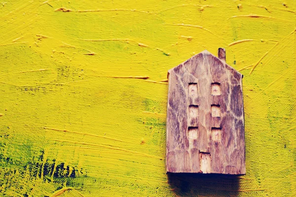 Wooden house on a yellow picturesque background. — Stock Photo, Image