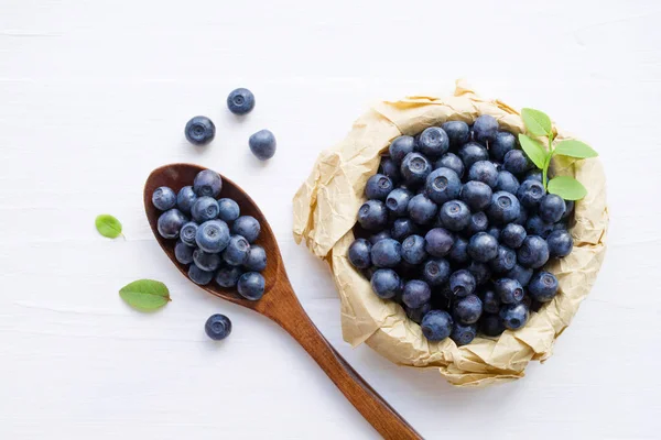 Fresh blueberries in a cup and a spoon — Stock Photo, Image