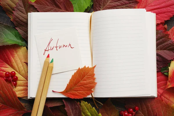 Autumn. An open notebook with the inscription Autumn, colored pencils — Stock Photo, Image