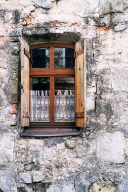 Wooden window on the texture wall of an old house