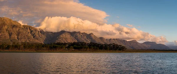 前景には湖があり 雲に覆われた美しい山脈のパノラマの風景 このショットは南アフリカの西ケープ州で撮影されました — ストック写真