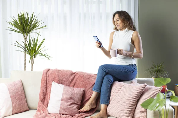 Woman using her mobile phone at hom — Stock Photo, Image