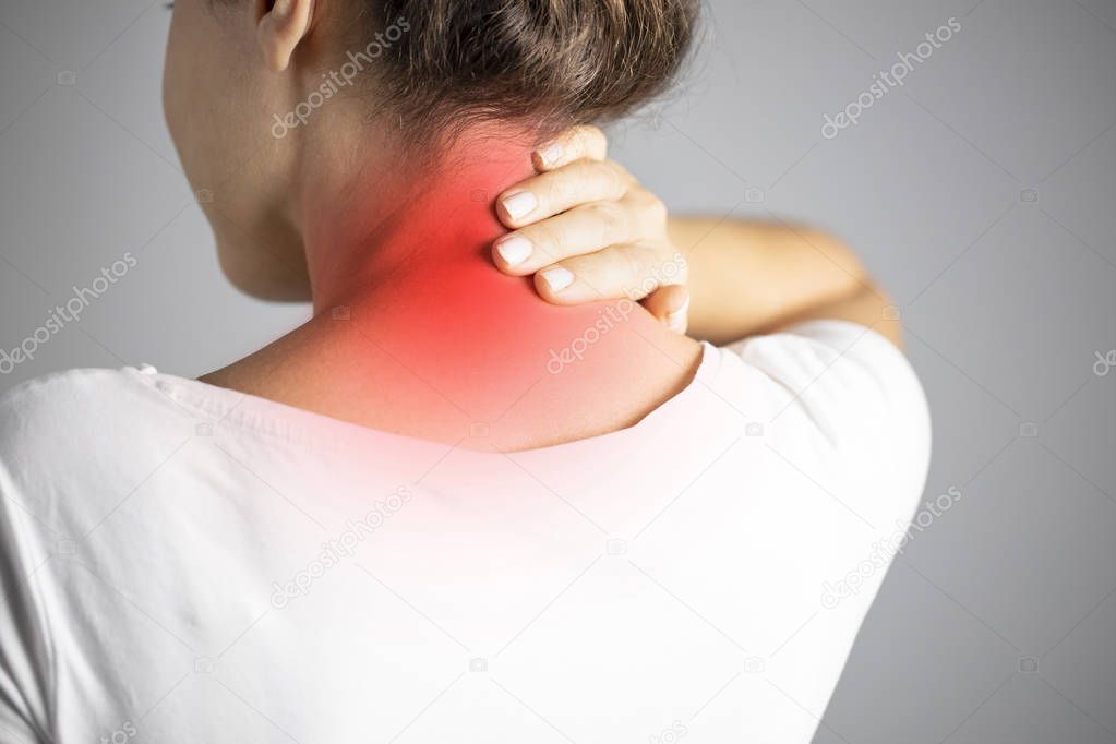 Rear view of young woman with neck pain